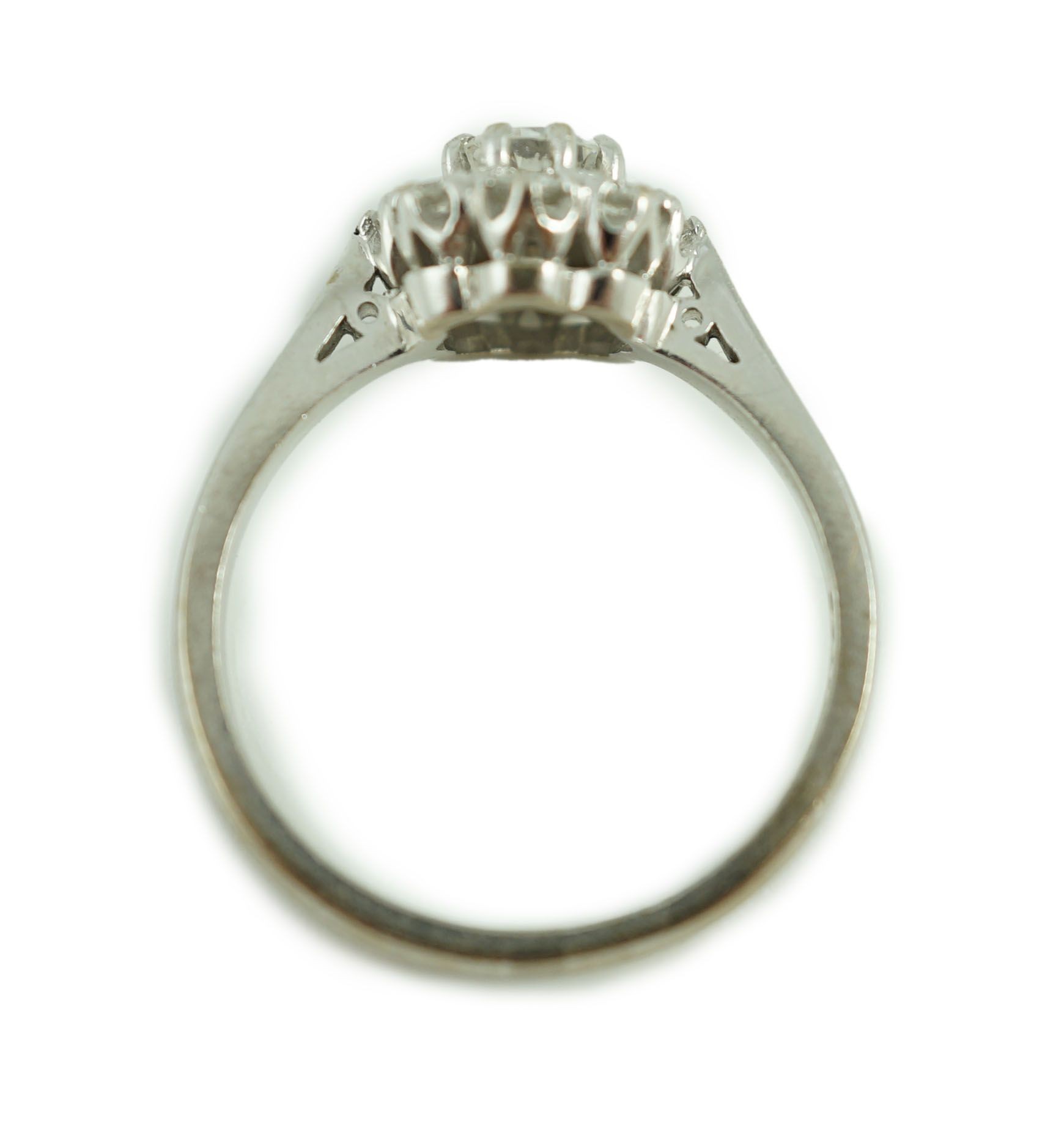 A modern 18ct white gold and nine stone diamond set flower head cluster ring